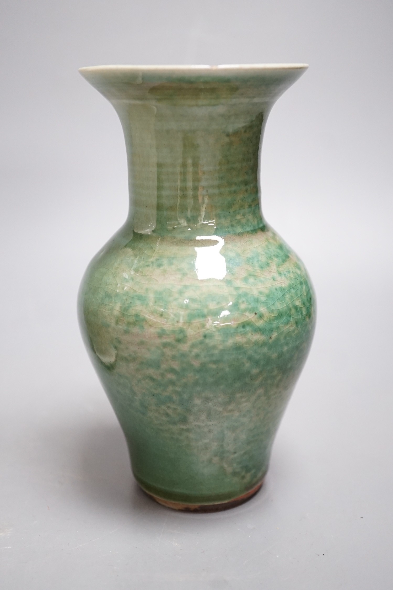 A Chinese white crackleware vase and a smaller green glazed vase